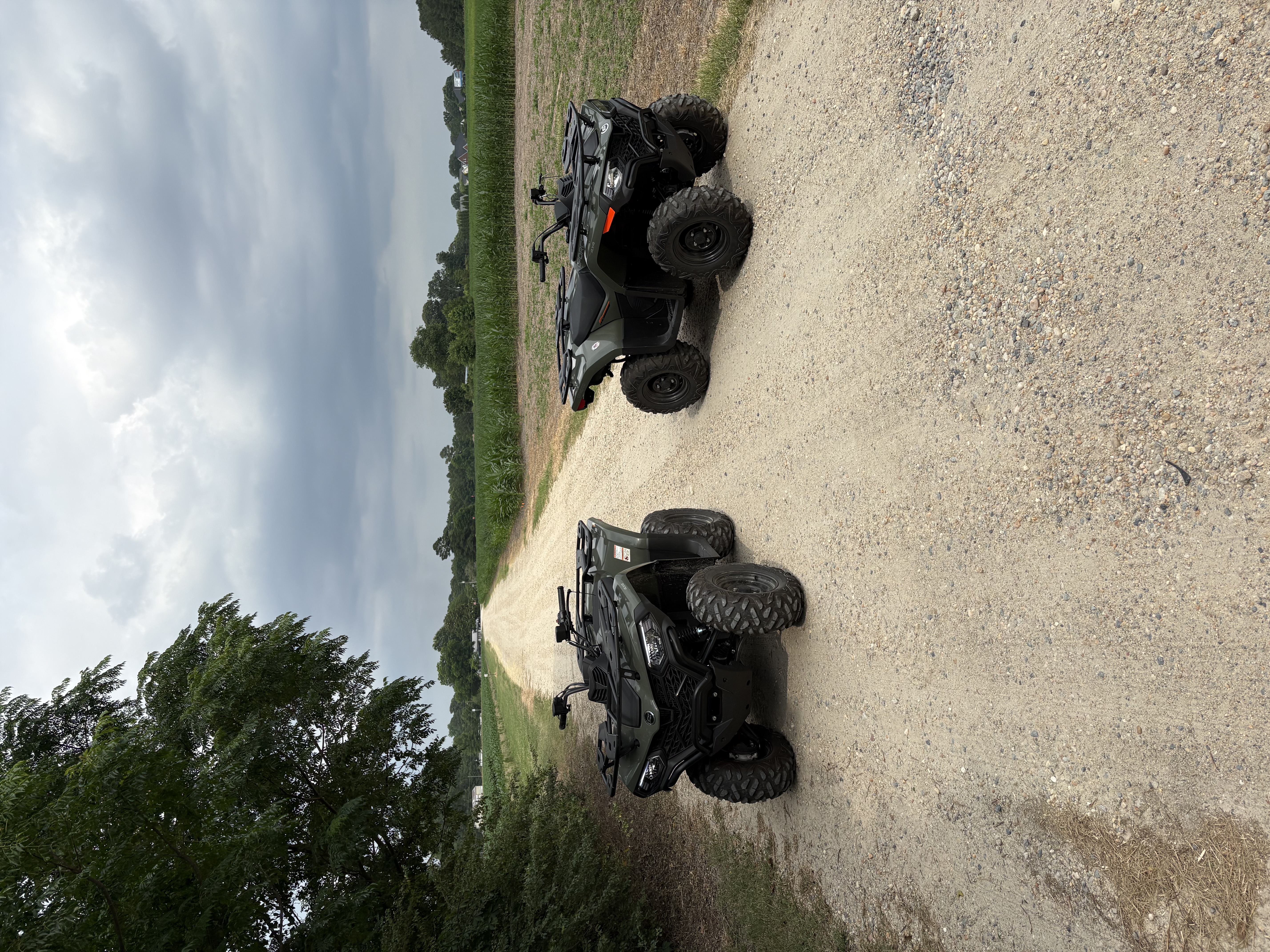 Two ATVs lined up on the trail